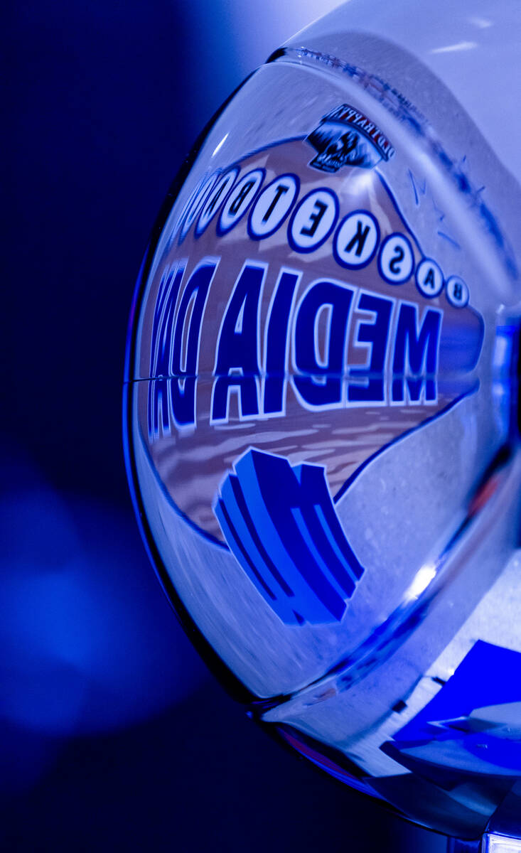 The Mountain West basketball logo is reflected on the championship trophy during media day at R ...