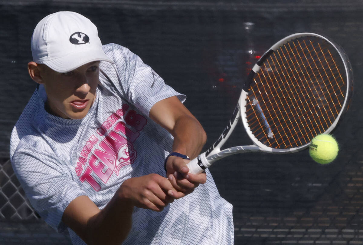 Liberty's Ray Ross returns the ball against The Meadows during the 4A tennis team State se ...