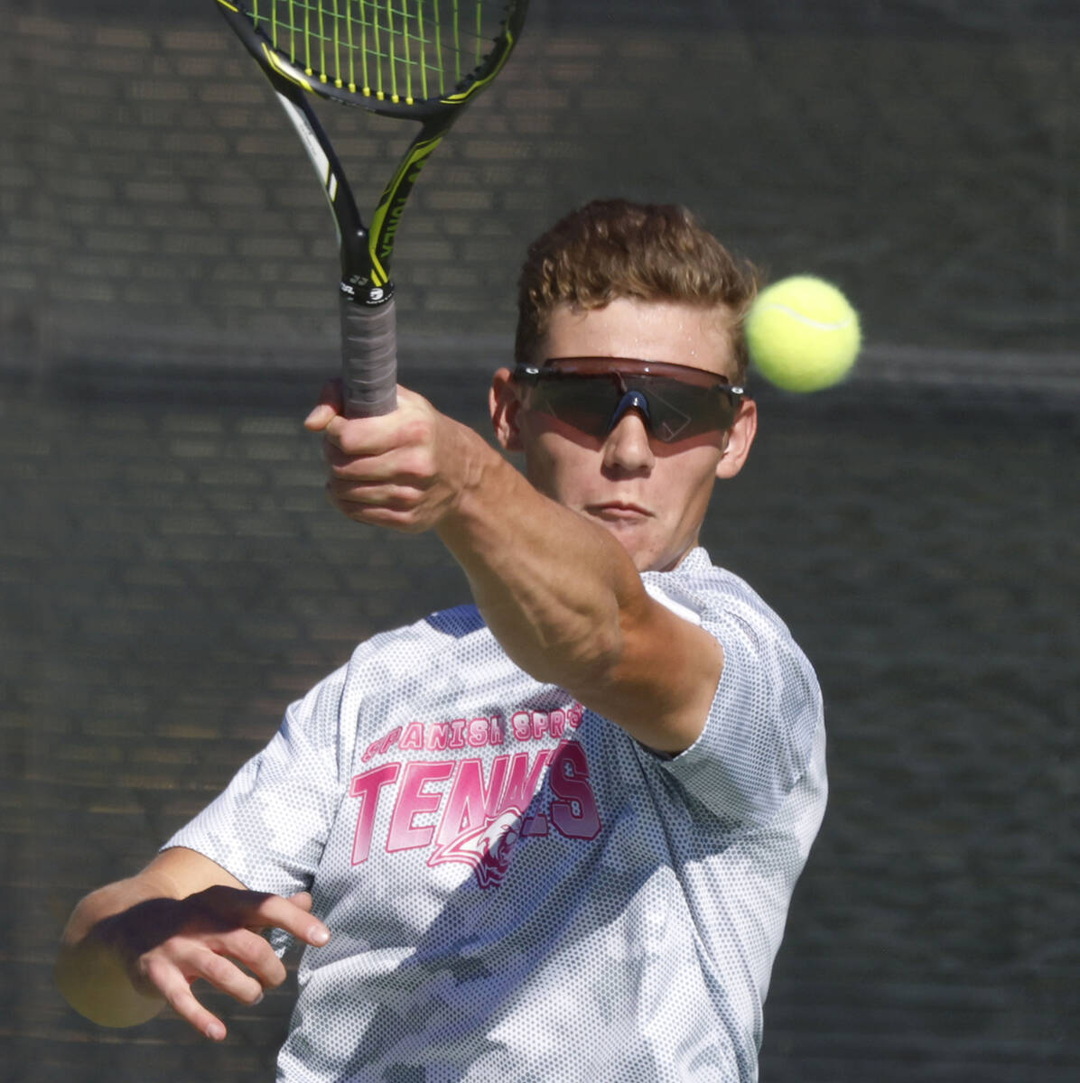 Liberty's Tristan Keller returns the ball against The Meadows during the 4A tennis team St ...