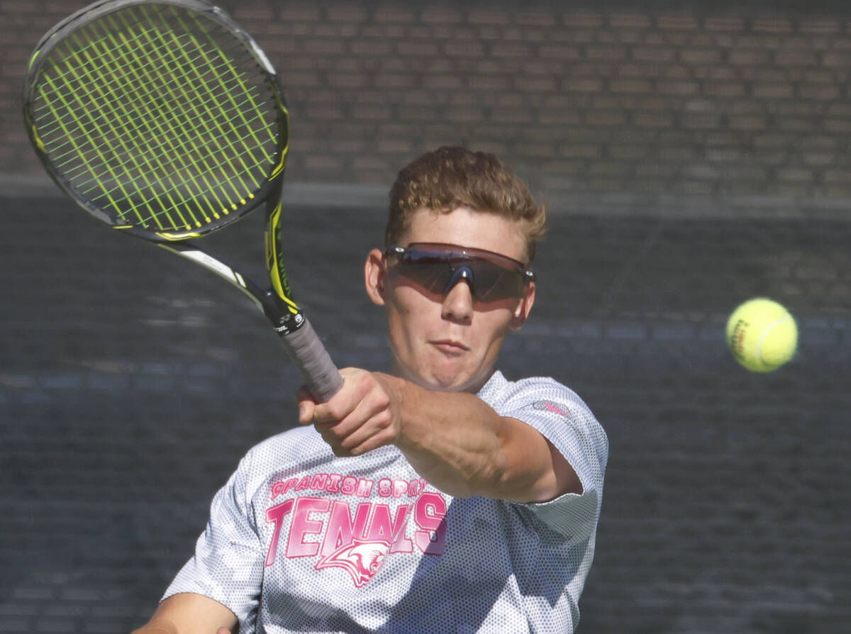 Liberty's Tristan Keller returns the ball against The Meadows during the 4A tennis team St ...