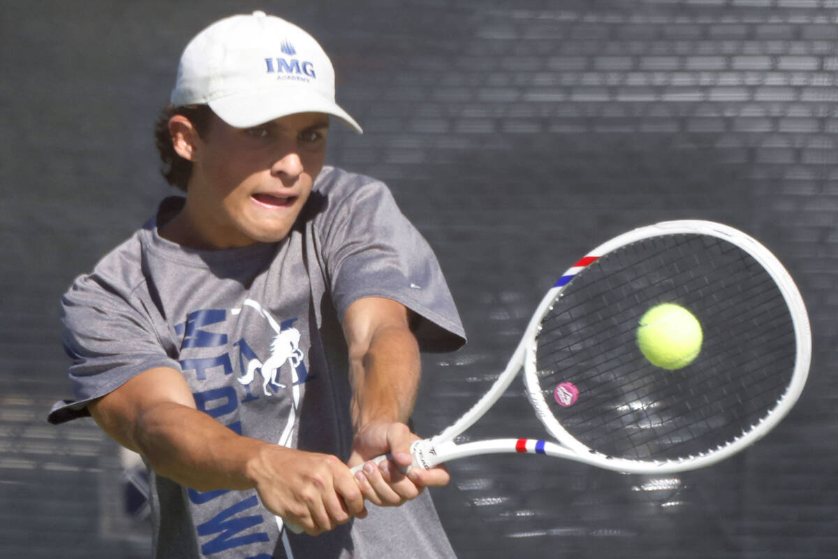 The Meadows' Jacob Garber returns the ball against Liberty during the 4A tennis team State ...
