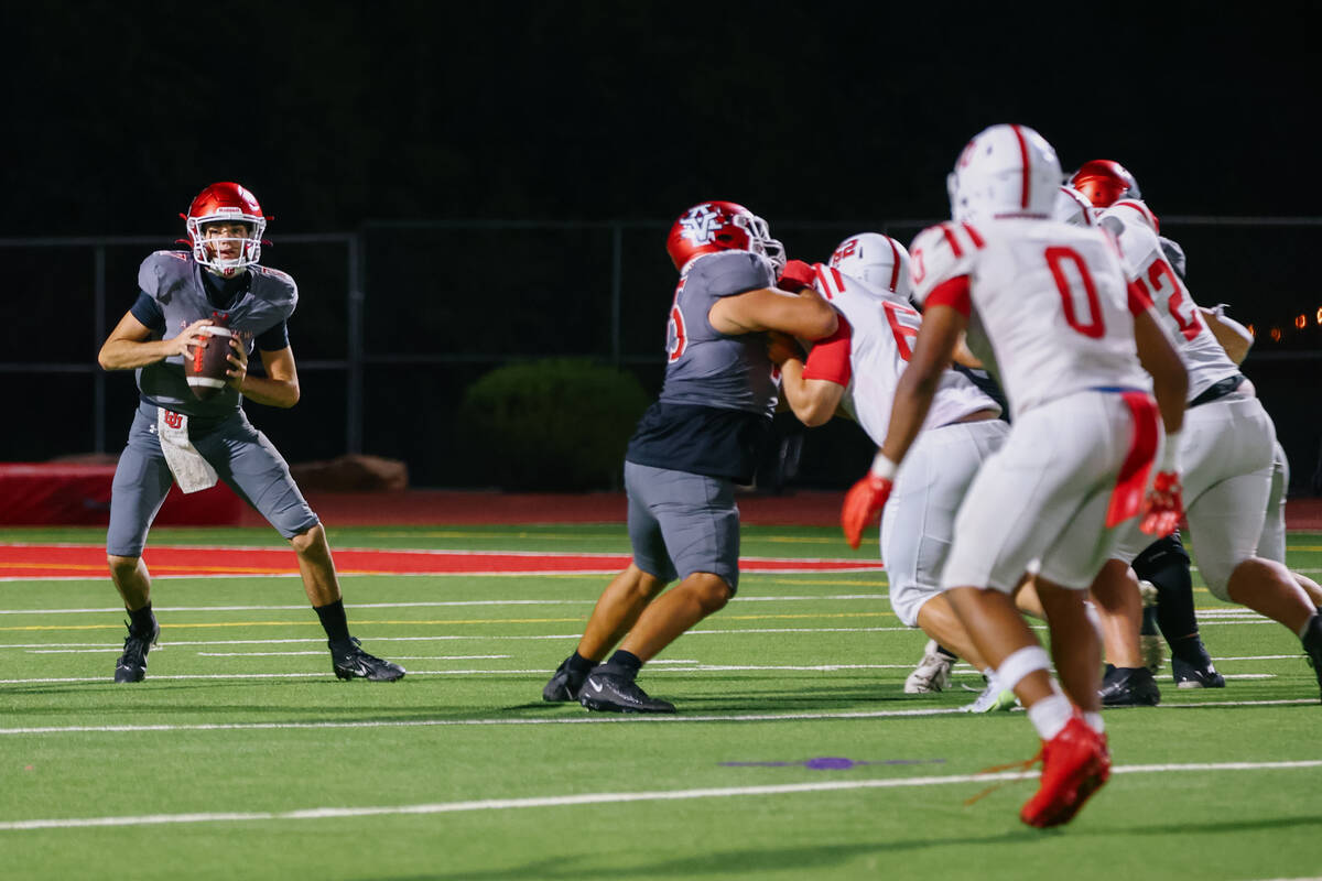 Arbor View quarterback Thaddeus Thatcher (7) looks for a teammate to pass to during a football ...