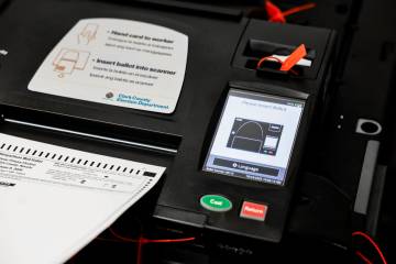 Lorena Portillo, (out of frame), Clark County Registrar of Voters, demonstrates step three, sca ...