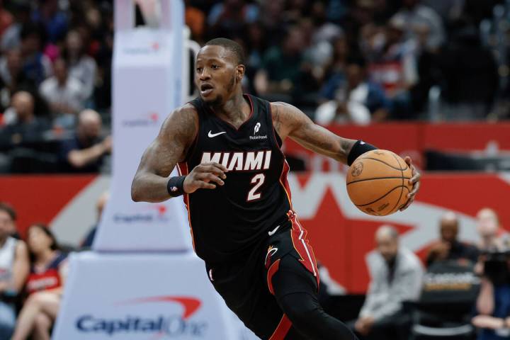 Miami Heat guard Terry Rozier (2) brings the ball up court during the second half of an NBA bas ...