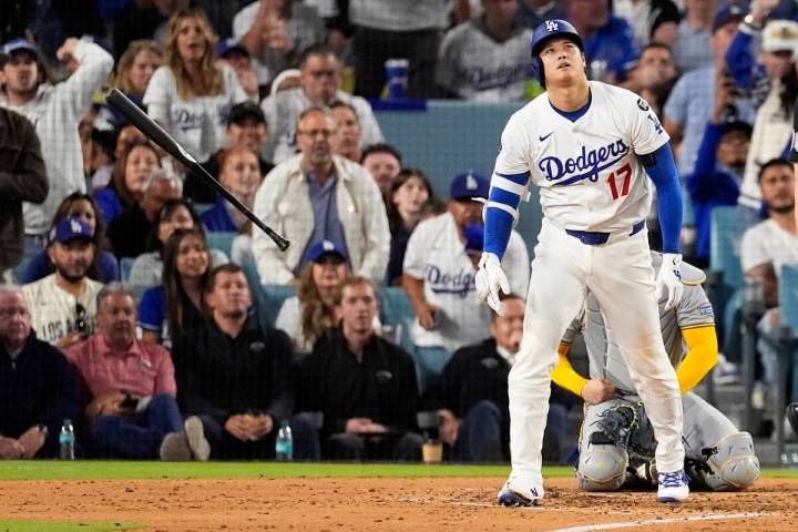 Los Angeles Dodgers' Shohei Ohtani watches his home run against the Milwaukee Brewers duri ...