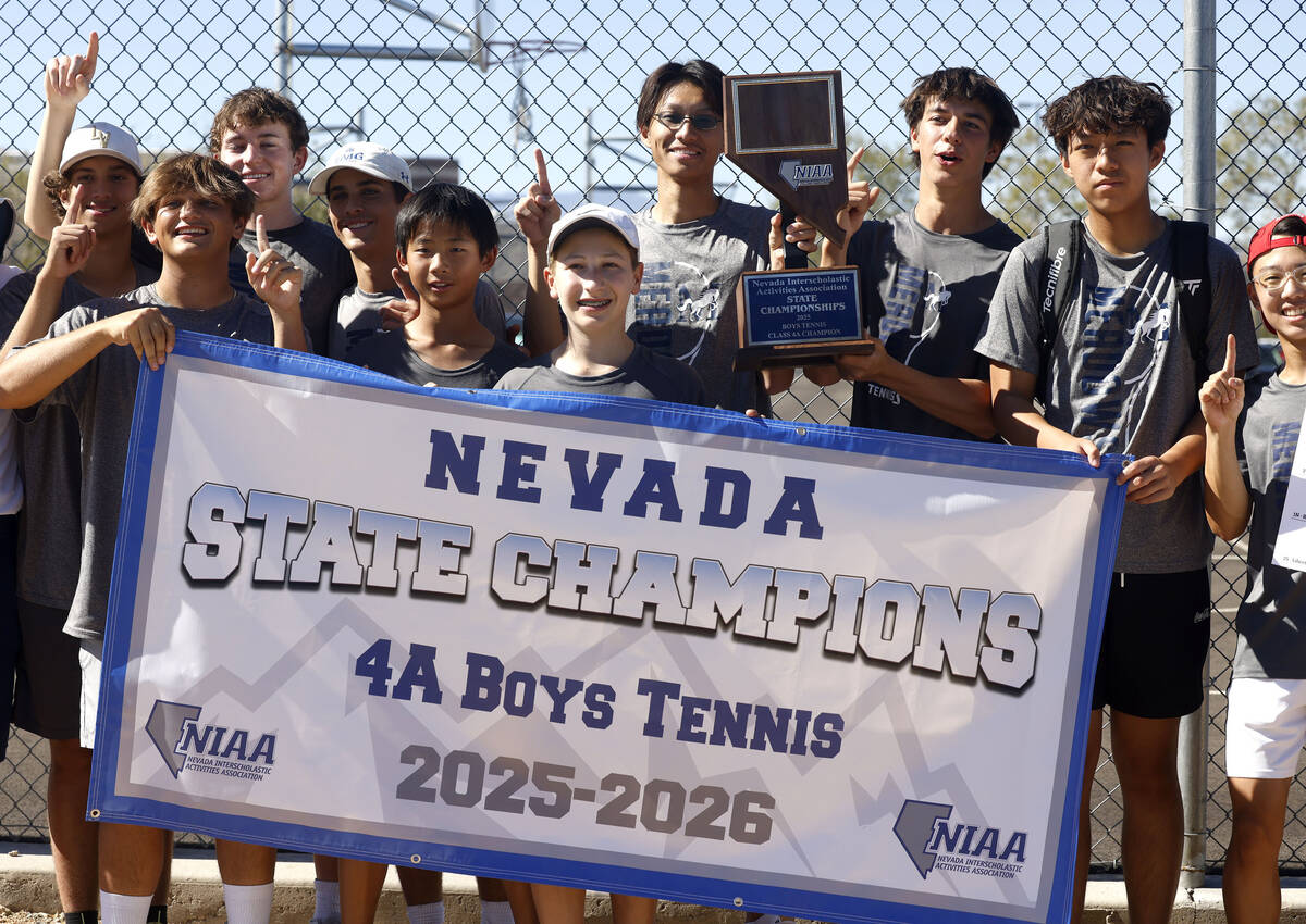 The Meadows boys' tennis team pose for a photo with their NIAA trophy after defeating Libe ...