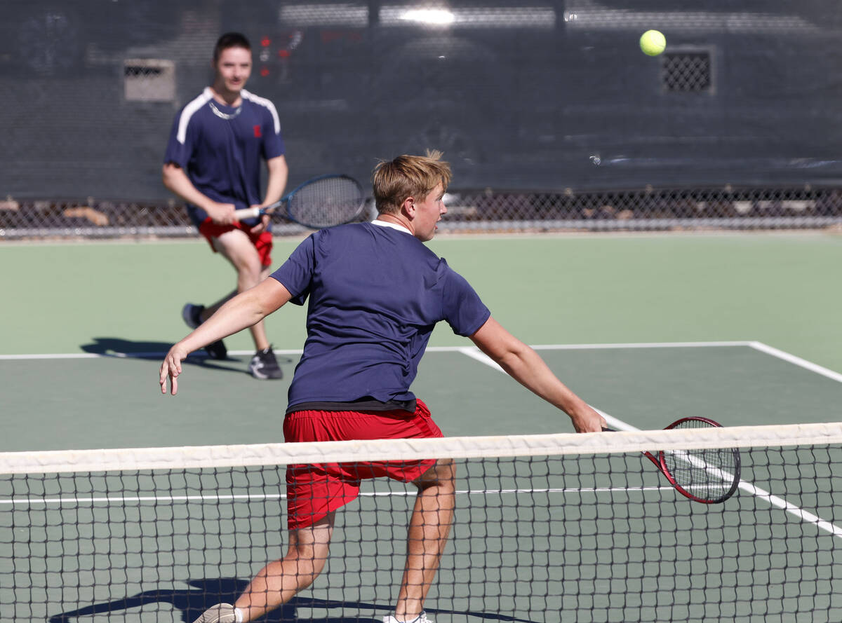 Liberty's Connor Casey, front, attempts to return the ball as his tennis partner Preston S ...