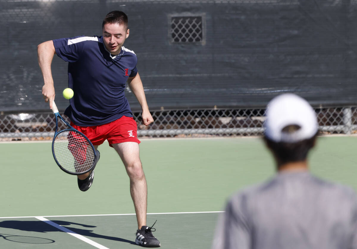 Liberty's Connor Casey returns the ball as The Meadows Steven Tian, right, looks on during ...