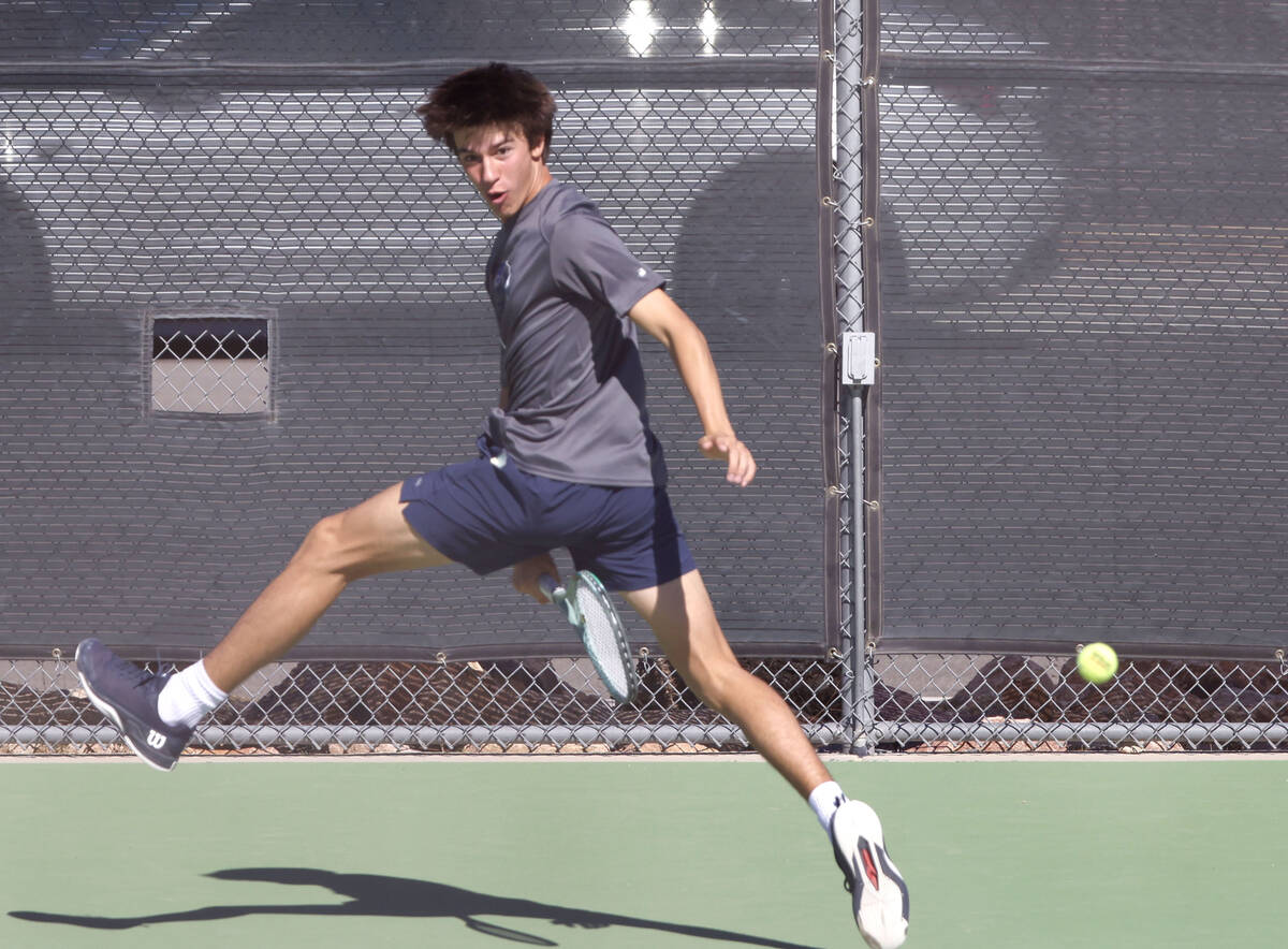 The Meadows Matt Maddox returns the ball between his legs during the Class 4A boys tennis team ...