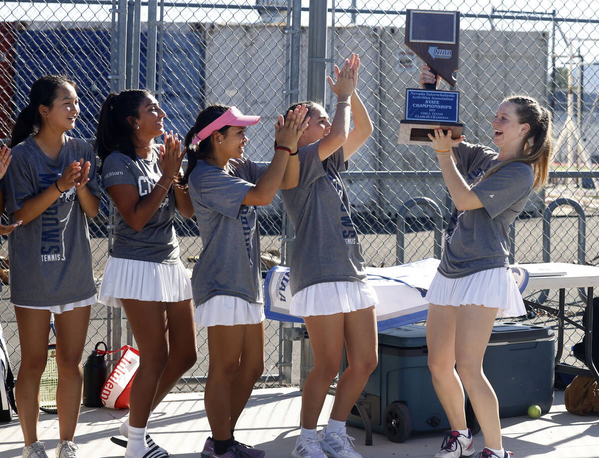 The Meadows girls' tennis team celebrates after defeating Spanish Springs in the Class 4A ...