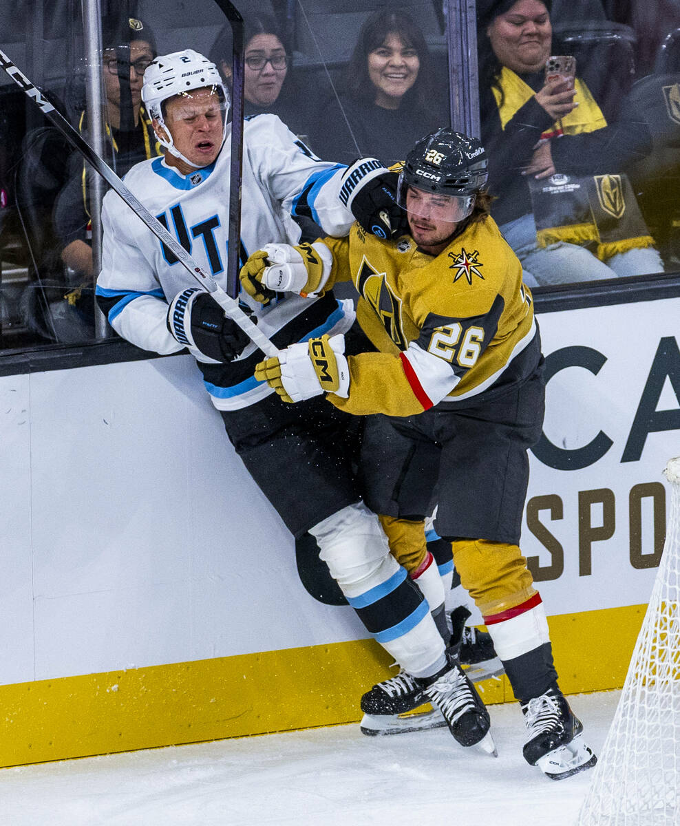 Utah Mammoth defenseman Olli Määttä (2) is driven into the boards by Golden Knig ...