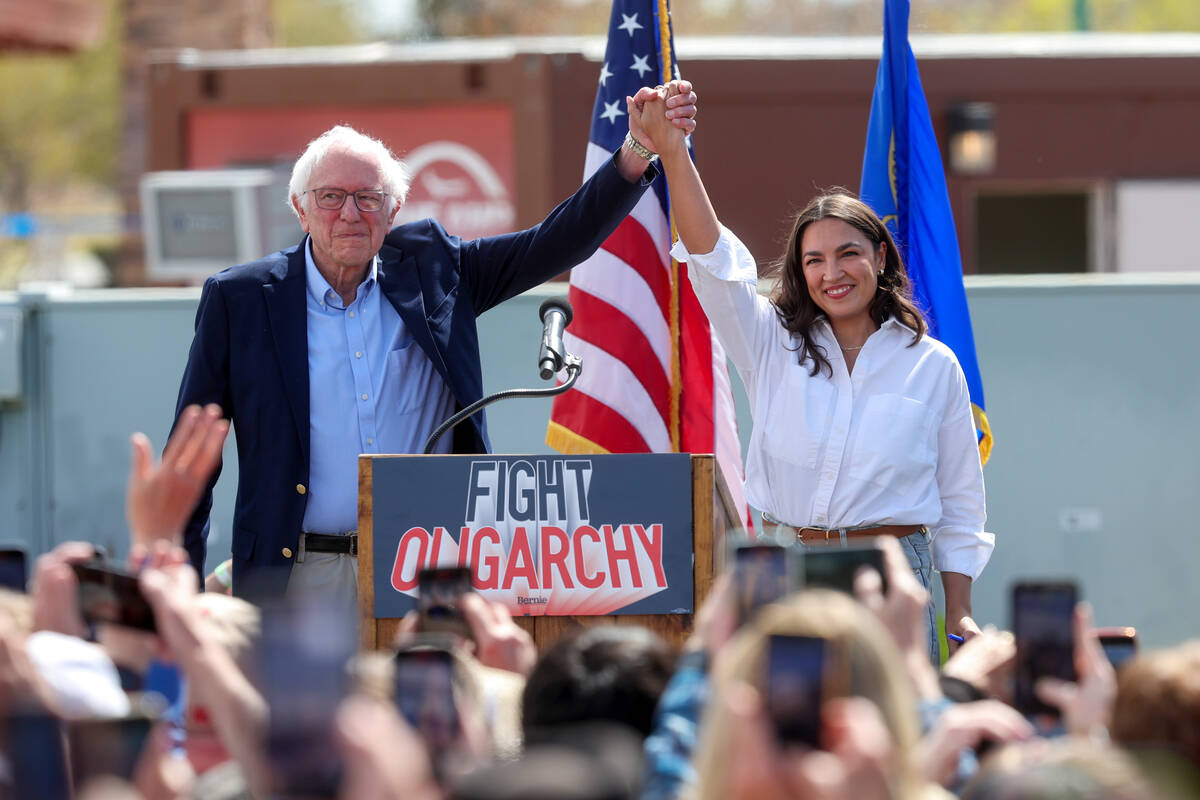 Sen. Bernie Sanders, I-Vermont, and Rep. Alexandria Ocasio-Cortez, D-N.Y., greet the crowd duri ...