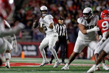 Oregon quarterback Dante Moore (5) looks to pass the ball during the first half of an NCAA coll ...
