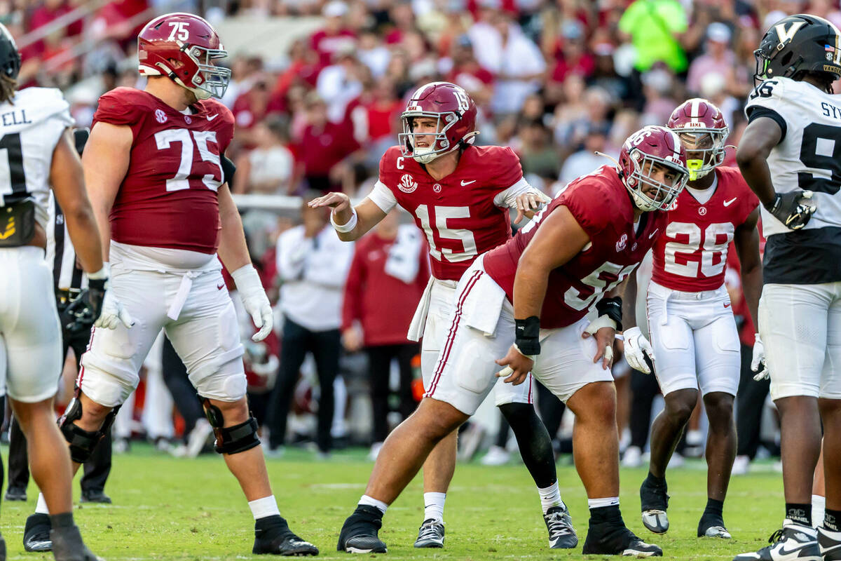 Alabama quarterback Ty Simpson (15) audibles at the line during the second half of an NCAA coll ...