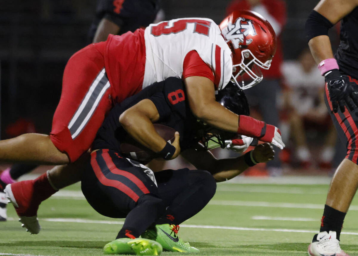 Las Vegas High's quarterback Tanner Vibabul (8) is taken down by Arbor View's defensi ...