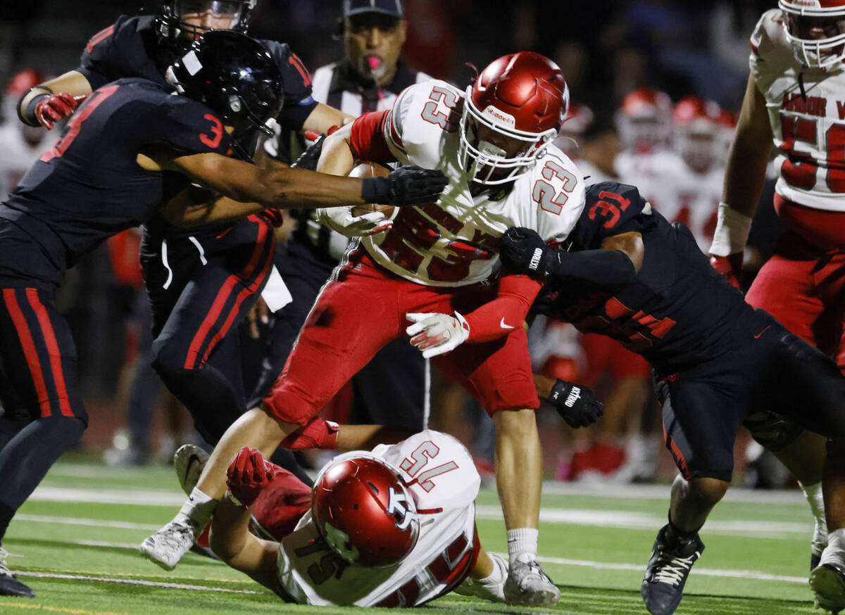 Las Vegas High's Andre Weigum (3) and Tyree Bush (31) attempt to take down Arbor View' ...