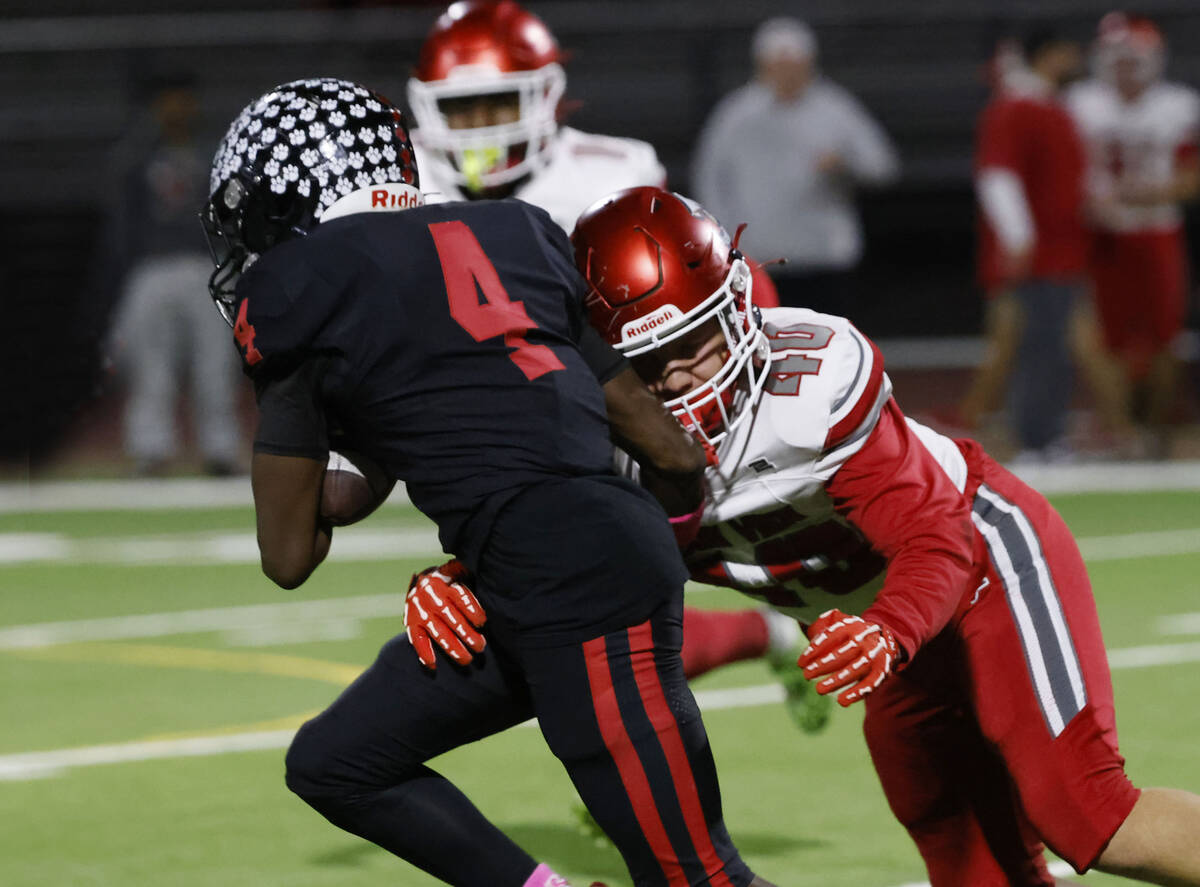 Arbor View's defensive tackle Joshua Kennard (40) tackles Las Vegas High's Steven Bul ...