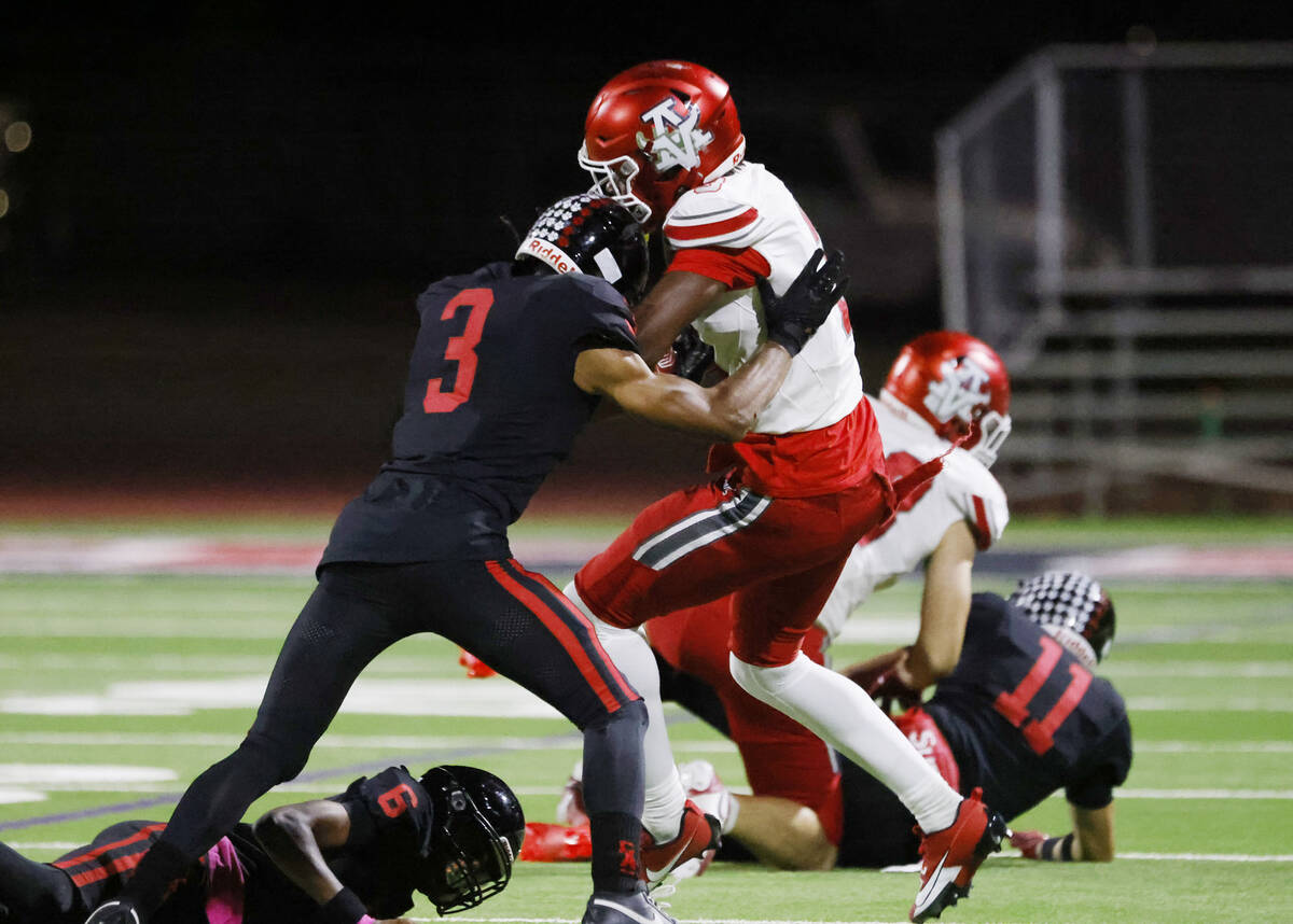 Las Vegas High's Andre Weigum, left, tackles Arbo View's wide receiver Damani Warren ...