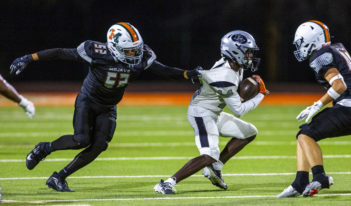 Mojave's Jaime Adame Jr. (52) catches Palo Verde's X'Zavier McZeal (14) from beh ...