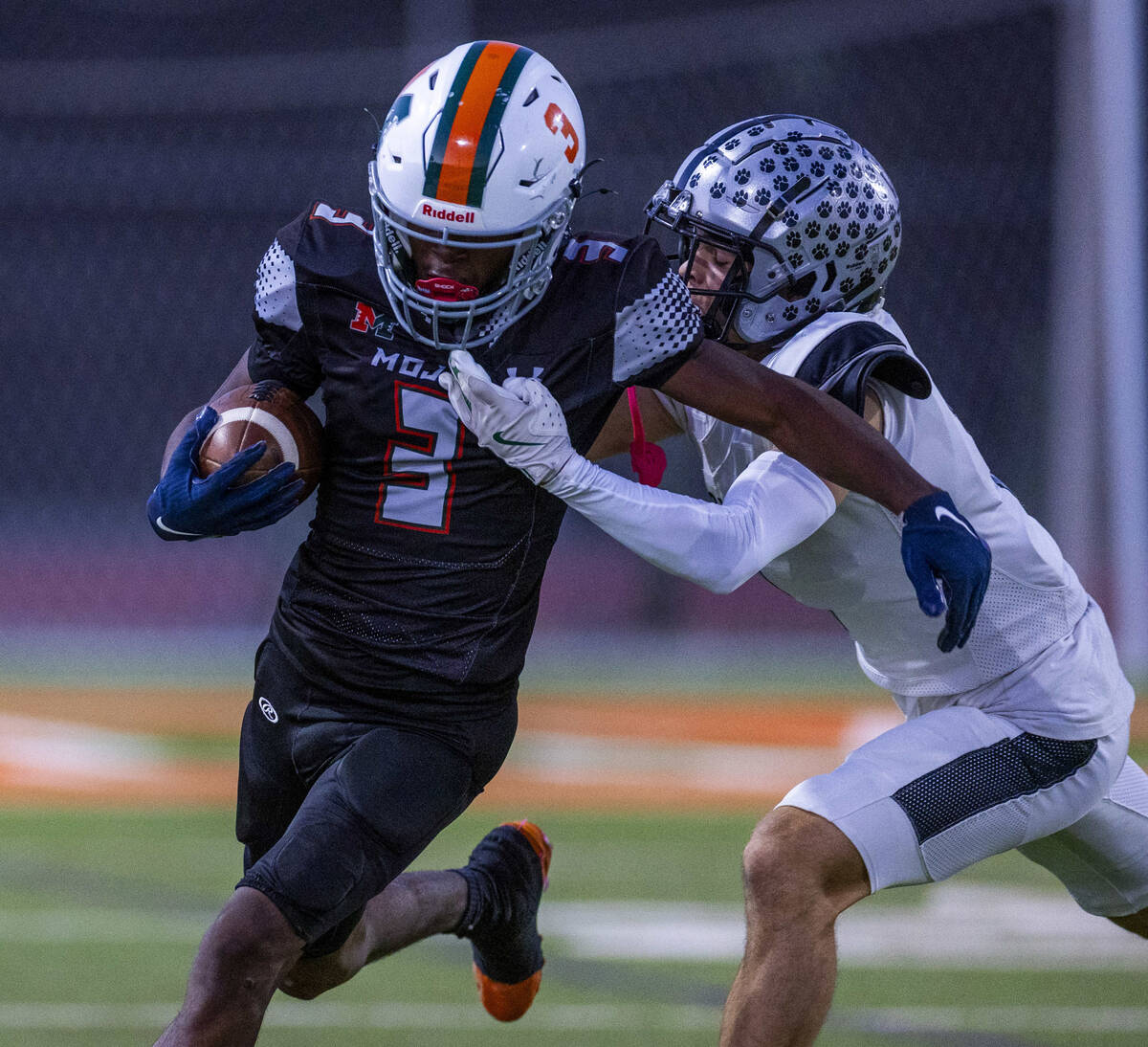 Mojave's S'marion Coleman (3) looks to break a tackle attempt by Palo Verde's Le ...