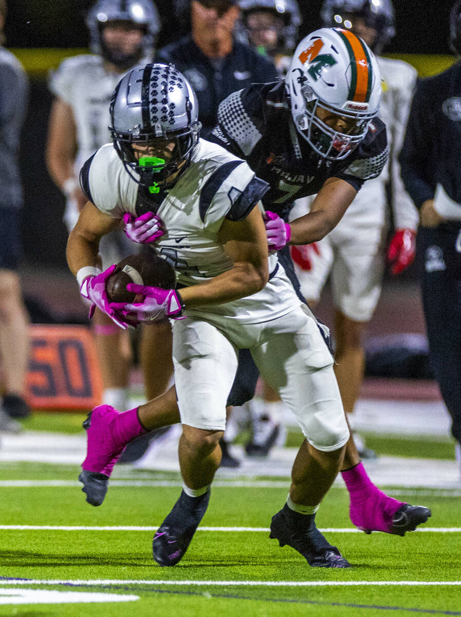 Palo Verde's Beau Gardineer (4) is grabbed by Mojave's Cedrick Stubblefield (7) after ...