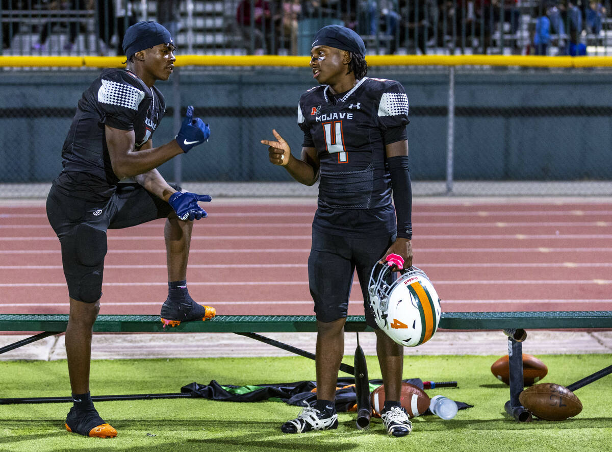 Mojave's S'marion Coleman (3) chats with quarterback RaJahn Butler (4) after another ...