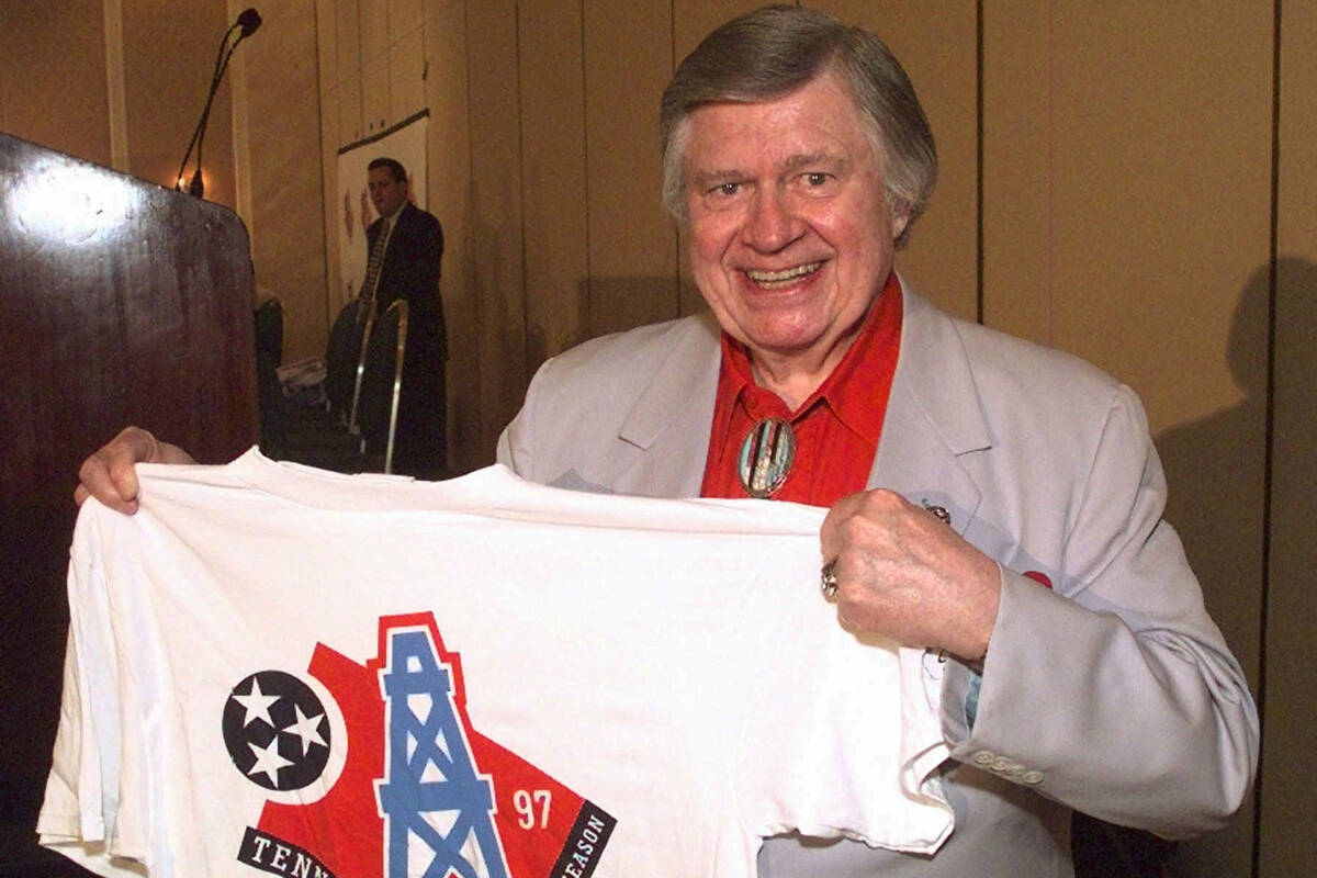 FILE - Houston Oilers owner Bud Adams shows off a T-shirt with the new logo the team will use w ...