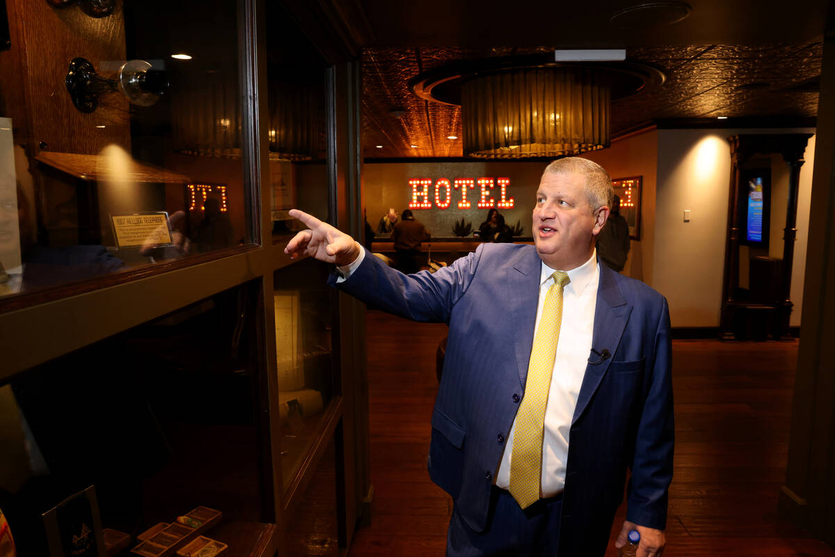 Golden Gate CEO Derek Stevens shows a model of the city’s first phone, which was installed at ...