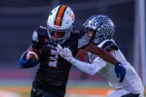 Mojave's S'marion Coleman (3) looks to break a tackle attempt by Palo Verde's Le ...