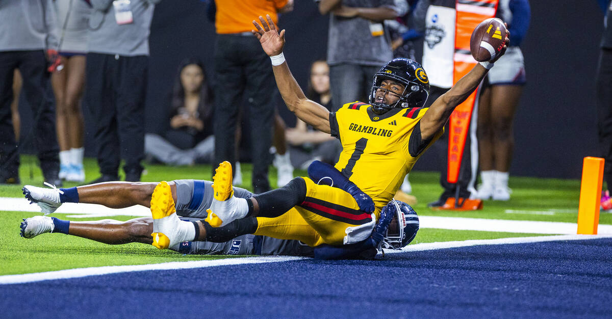 Grambling State Tigers quarterback C'Zavian Teasett (1) rolls into the end zone over Jacks ...