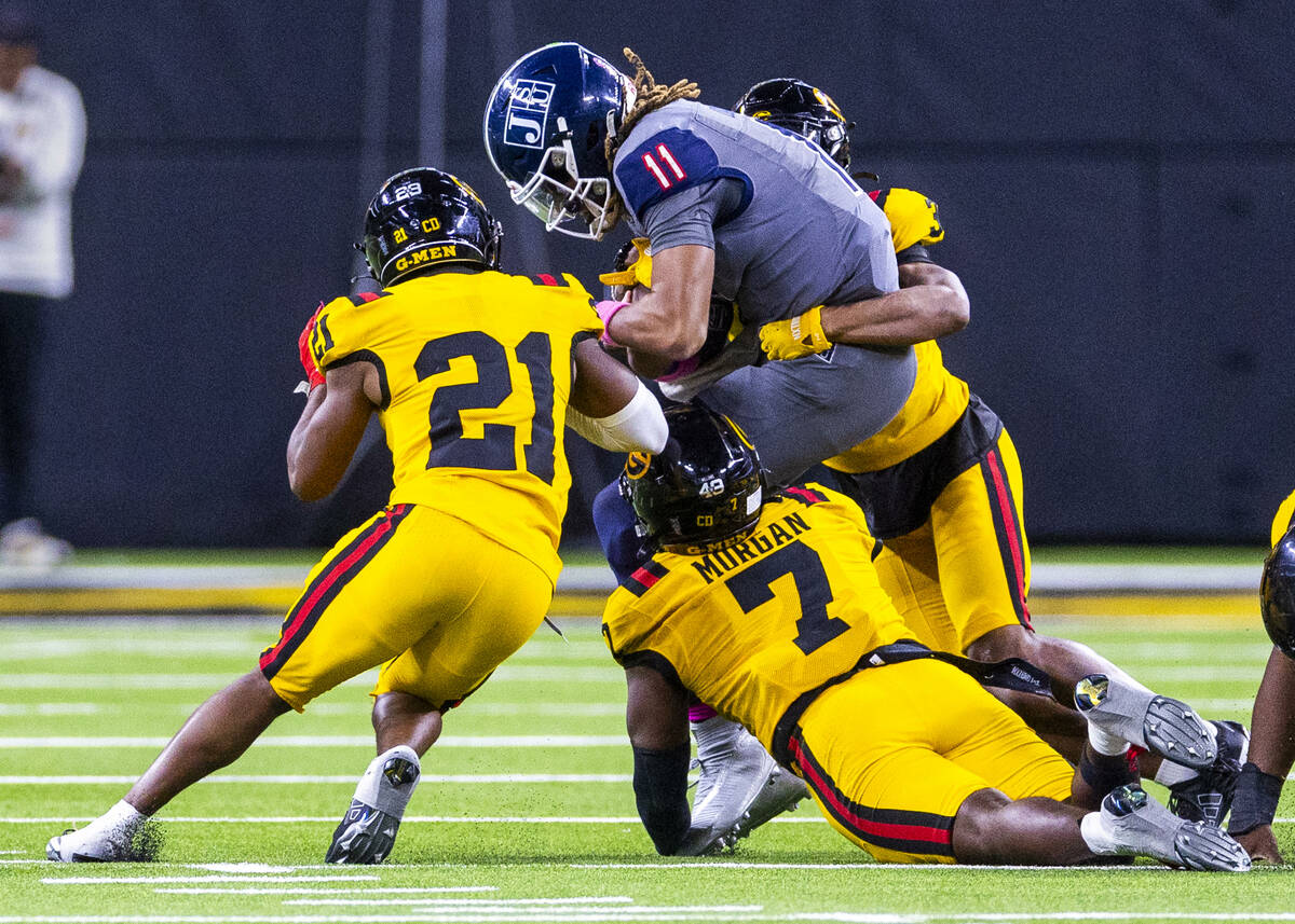 Jackson State Tigers quarterback Jared Lockhart (11) is team tackle by Grambling State Tigers d ...