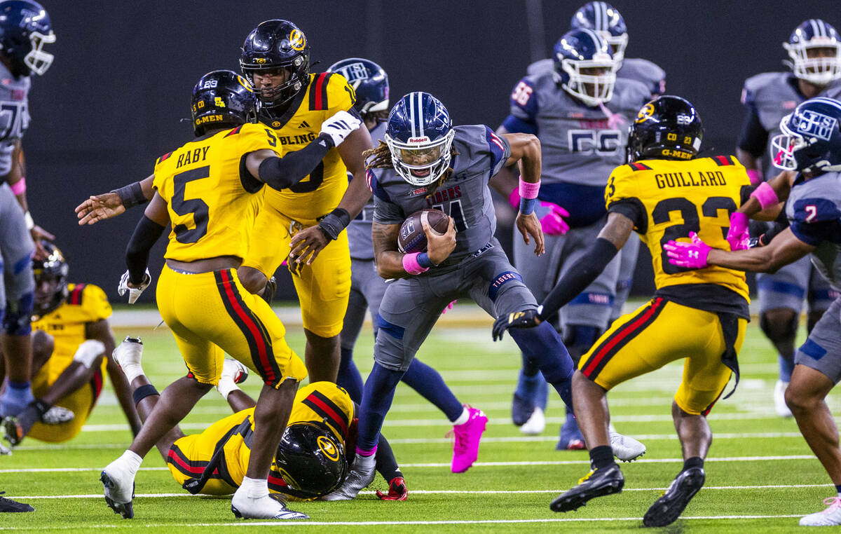 Jackson State Tigers quarterback Jared Lockhart (11) breaks a tackle attempt by Grambling State ...