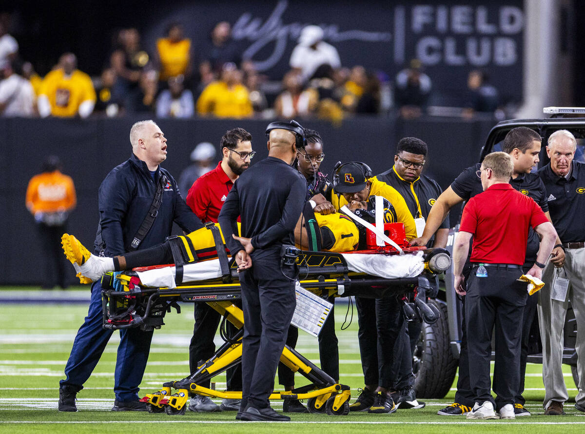 Grambling State Tigers head coach Mickey Joseph talks closely with quarterback C'Zavian Te ...