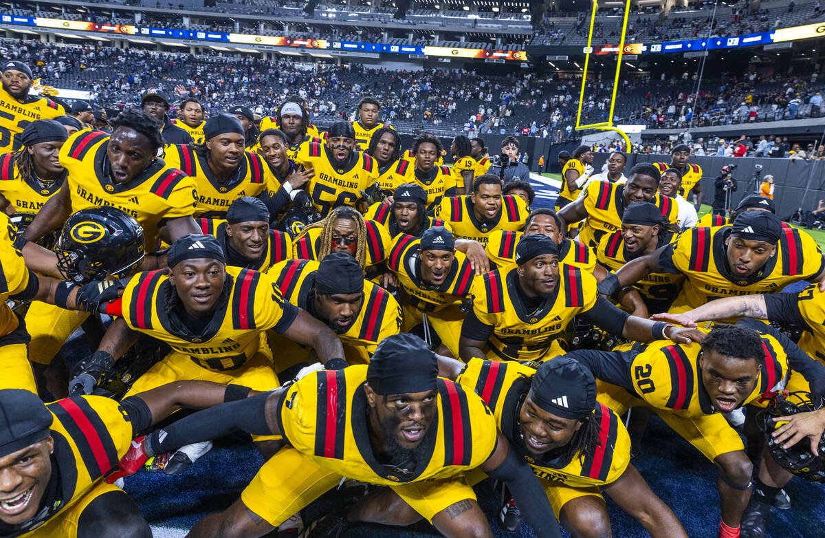 Grambling State Tigers players weave together in celebration after deflation the Jackson State ...