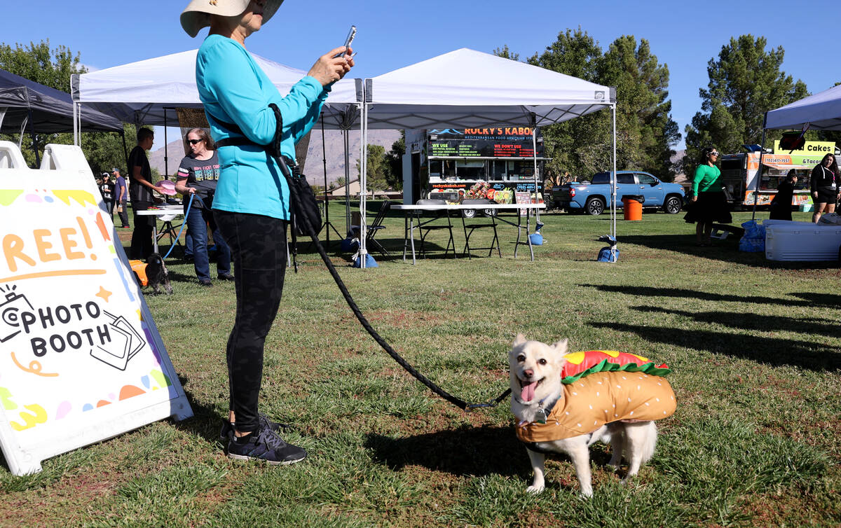 Beth Alcain takes a photo of her dog Bailey during the Sixth Annual Paws in the Park event at A ...