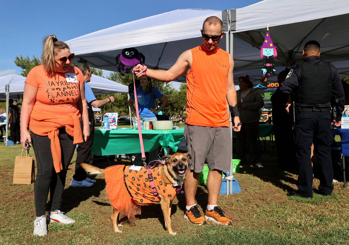 Elaina and Mike DeNutte walk check out the booths with their dog Gypsy during the Sixth Annual ...