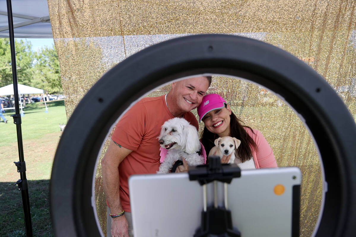 Jimmy and Taina Vega pose int the Photo Booth with their dogs Brooklyn, left, and Rico during t ...