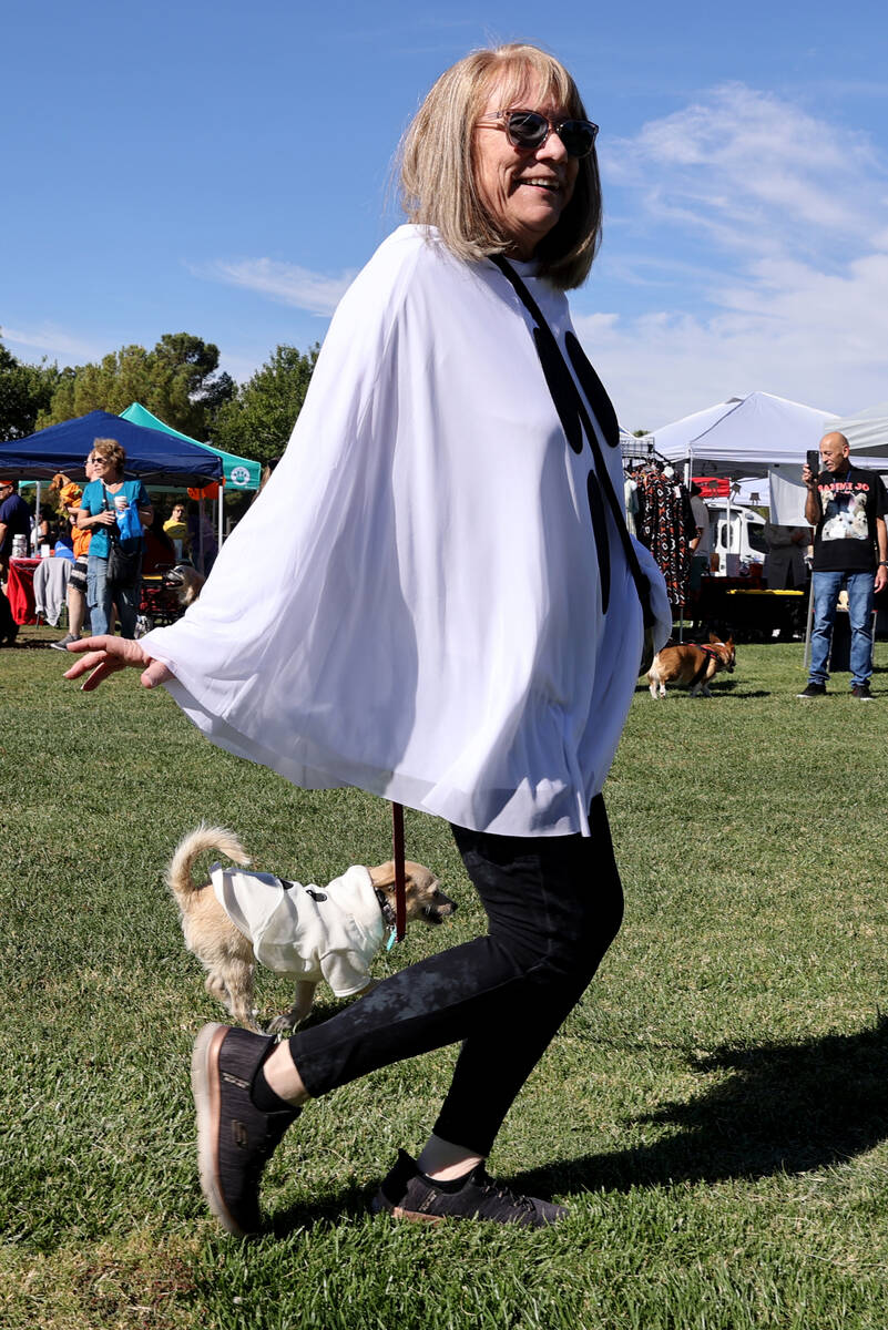 Participants walk in the doggie “paw-rade” during the Sixth Annual Paws in the Pa ...