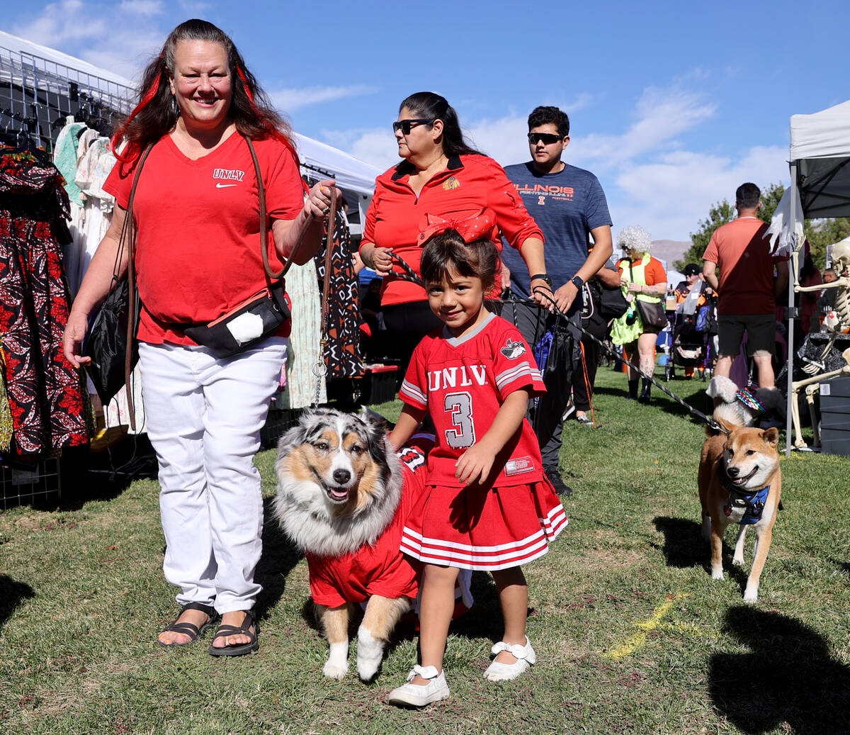 Susan and Scarlett Garrett, 4, walk with their dog Pistol Annie during the Sixth Annual Paws in ...