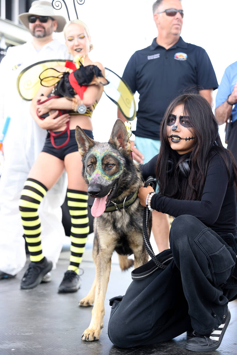 Casey Parra and her dog and Valentino take first place in Halloween dog costume contest during ...
