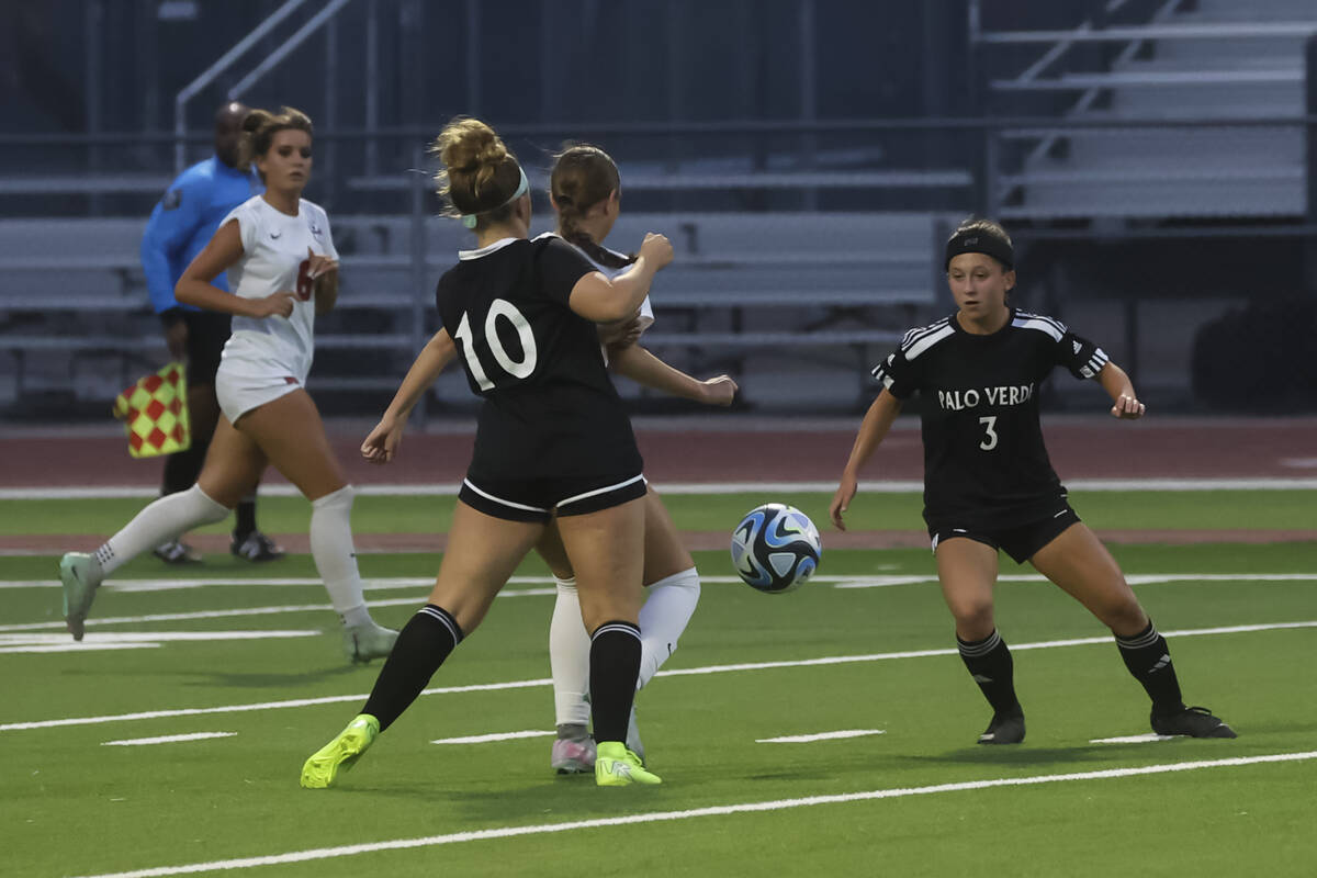 Palo Verde's Brooke Bolinger (10) and Olivia Gastwirth (3) try to get the ball from Corona ...