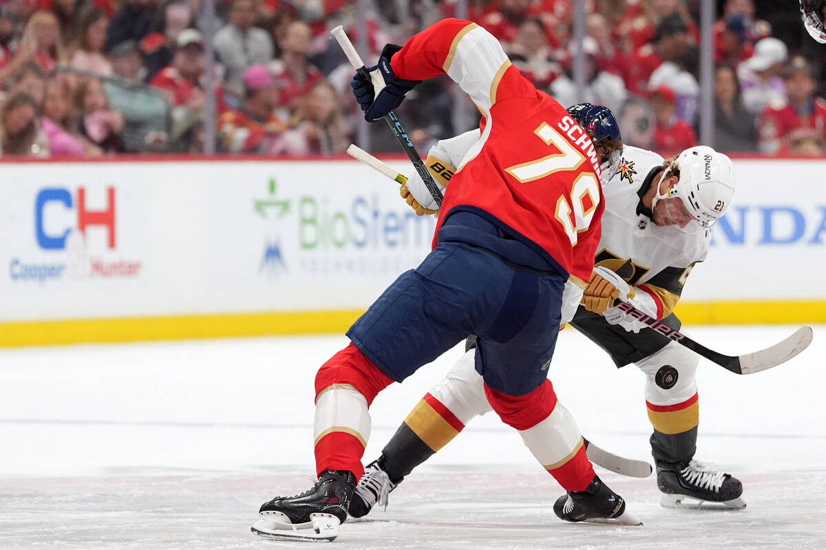 Vegas Golden Knights center Brett Howden (21) faces off against Florida Panthers center Cole Sc ...