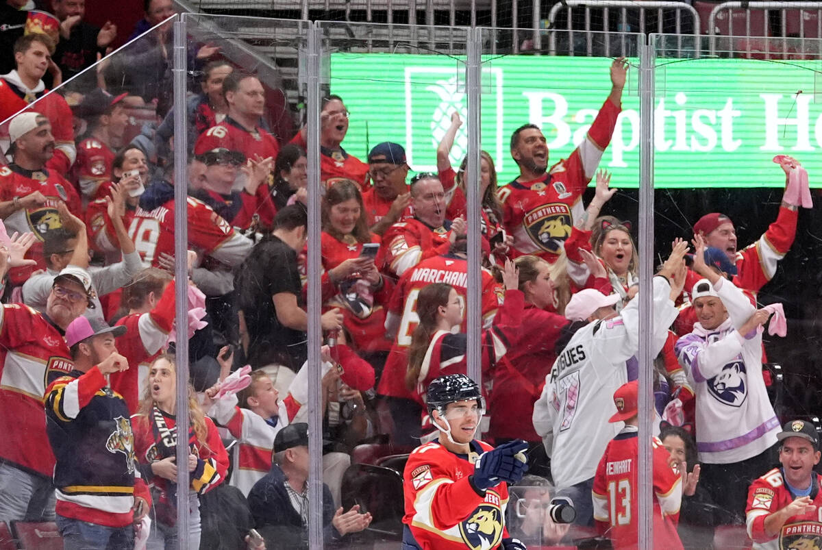 Florida Panthers center Evan Rodrigues (17) and fans celebrate after the team's first goal ...