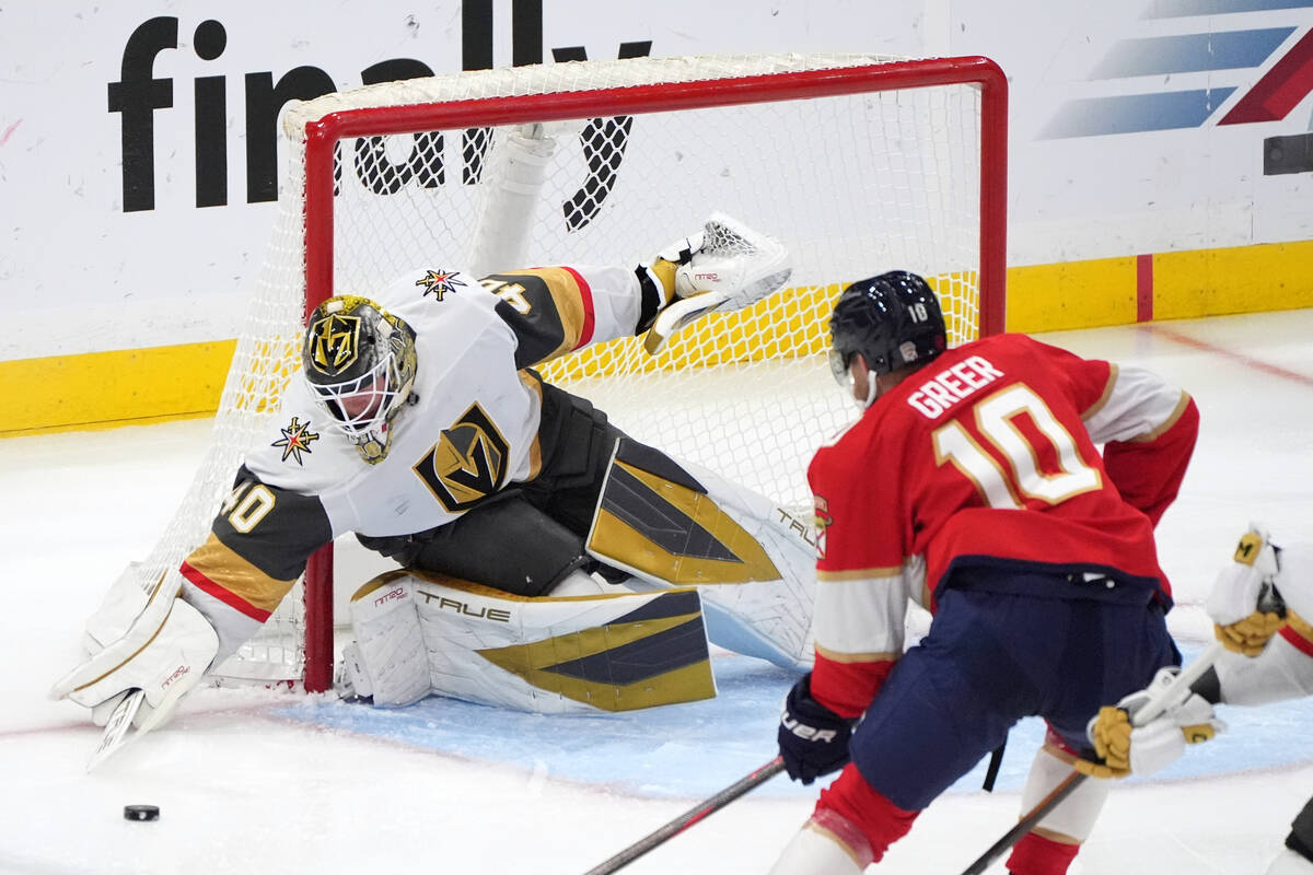 Vegas Golden Knights goaltender Akira Schmid (40) goes for a puck under pressure from Florida P ...