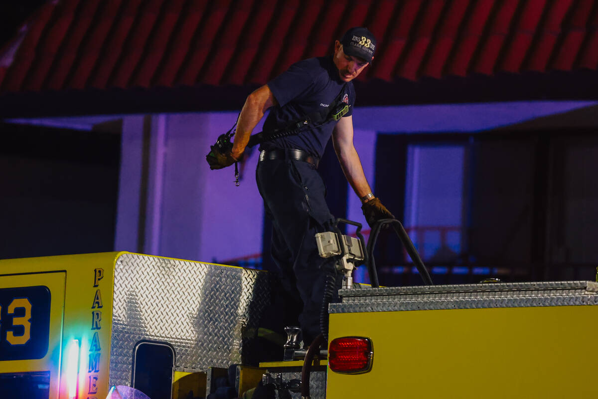 Investigators sift through remains from a fire after a woman was found dead at the Casa Vegas c ...