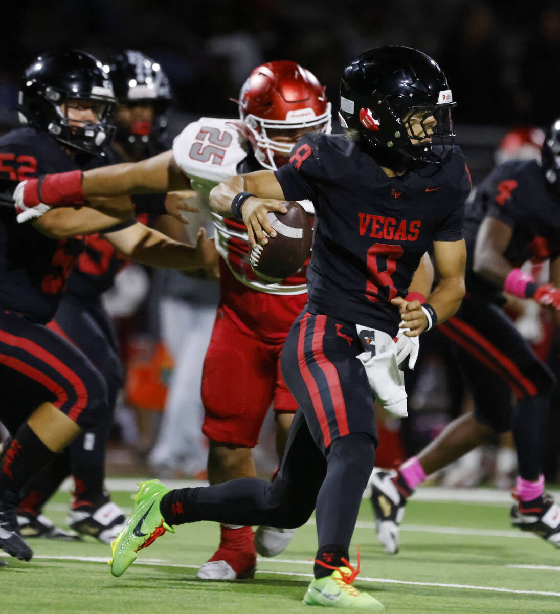 Las Vegas High's quarterback Tanner Vibabul (8) is chased by Arbor View's defensive ...