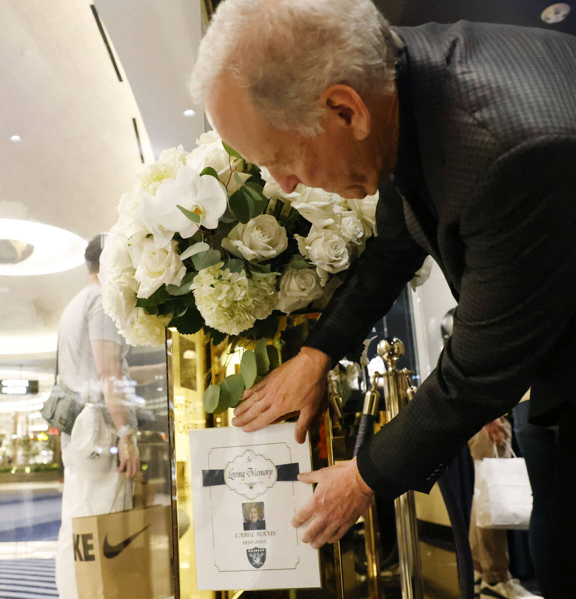 Sportscasting legend Jim Gray places a memorial message alongside flowers, in honor of Carol Da ...