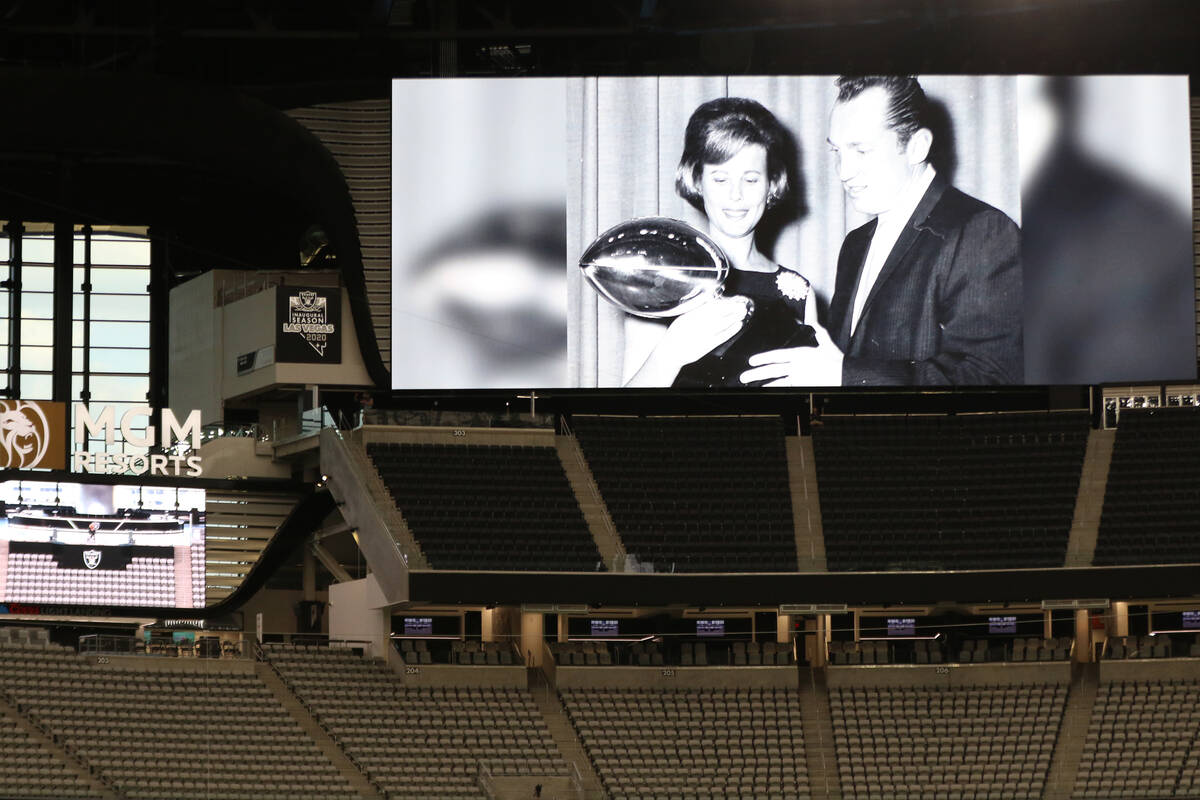 Carol Davis, left, is pictured holding the Raiders' Super Bowl trophy next to her late hus ...