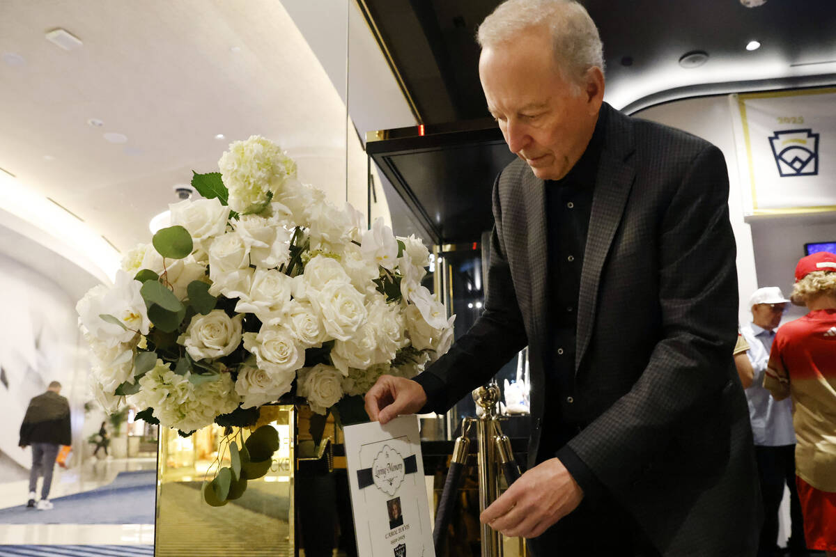 Sportscasting legend Jim Gray places a memorial message alongside flowers, in honor of Carol Da ...