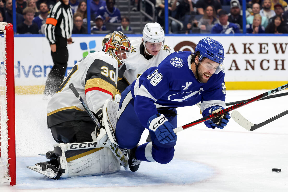 Tampa Bay Lightning's Brandon Hagel (38) is knocked into Vegas Golden Knights goaltender C ...
